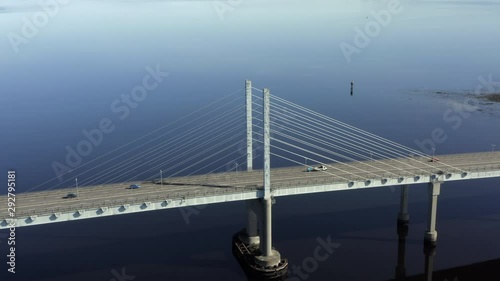 An aerial view of Kessock Bridge in Inverness on a sunny summer's morning. Flying away from a central columnn of the bridge. photo