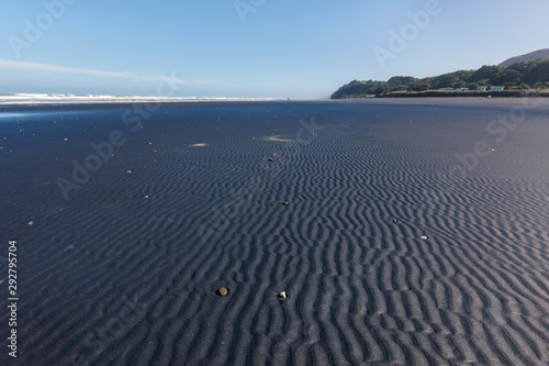 Black sandy beach near New Plymouth  New Zealand