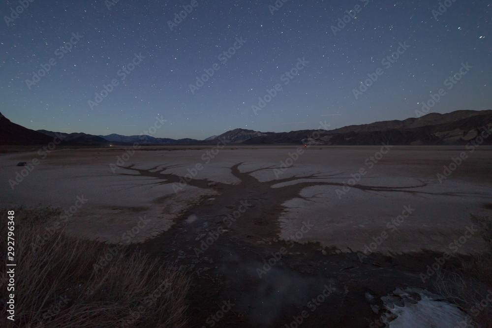 Racetrack Playa in Death Valley National Park on a clear night with endless stars in the sky
