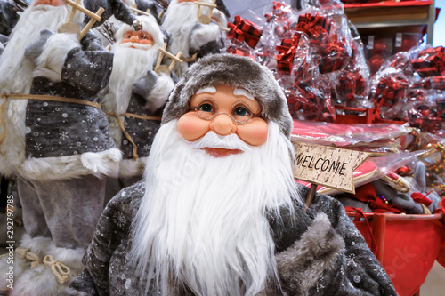 A gray Santa Claus-like doll is looking up.