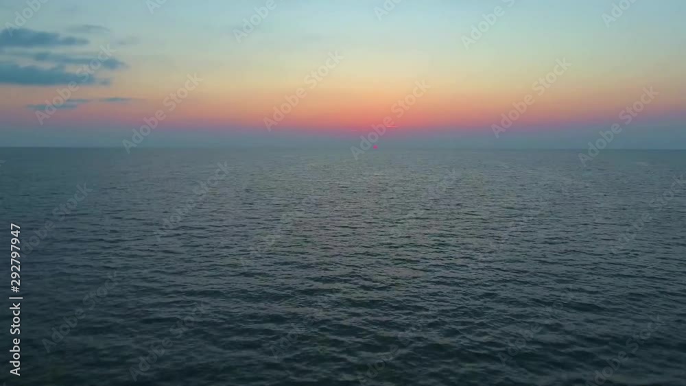A low aerial scene. A camera flies forward over the sea to sunset A low aerial scene. A camera flies forward over the sea to sunset