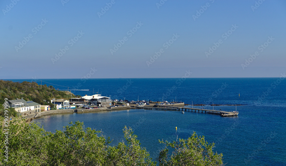 Beach pier with calm sea during sunny day with blue sky