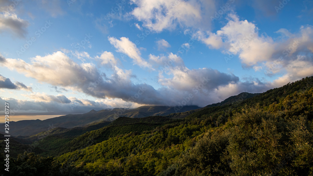 Cloudscape sunrise in Catalan Pyrenees over green mountains