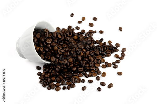 coffee beans spilling out of a cup isolated on white background.