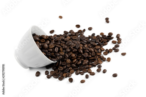 coffee beans spilling out of a cup isolated on white background.