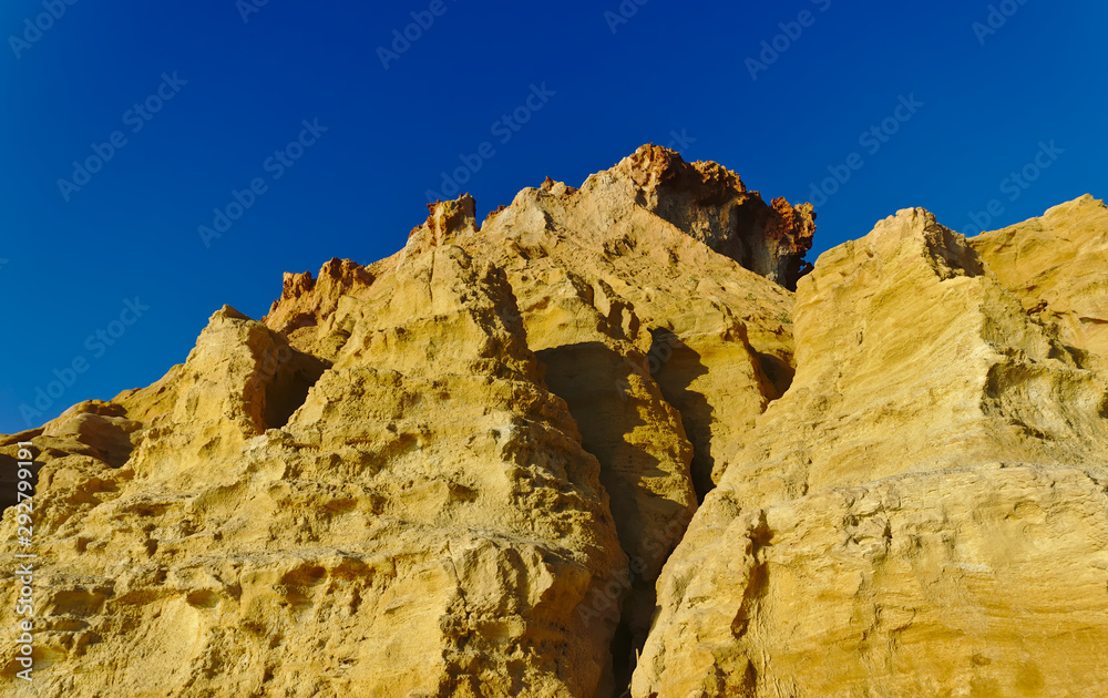 Yellow cliffs with blue sky in background