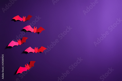bats papercut in purple background for halloween