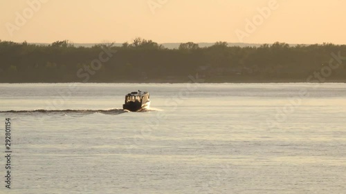 Fishing schooner at sunset, swimming fast.