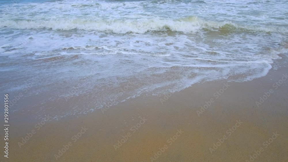 Beautiful background transparent surface wave, sand on clean seaside beach. Royalty high-quality free stock video footage of clean surface seawater, waves on the beach with sand and sunshine in summer Beautiful background transparent surface wave, sand on clean seaside beach. Royalty high-quality free stock video footage of clean surface seawater, waves on the beach with sand and sunshine in summer
