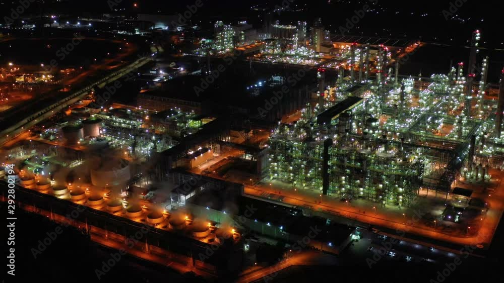 Aerial view night light oil terminal is industrial facility for storage of oil and petrochemical. oil manufacturing products ready for transport and business transportation. power electric plant. Aerial view night light oil terminal is industrial facility for storage of oil and petrochemical. oil manufacturing products ready for transport and business transportation. power electric plant.