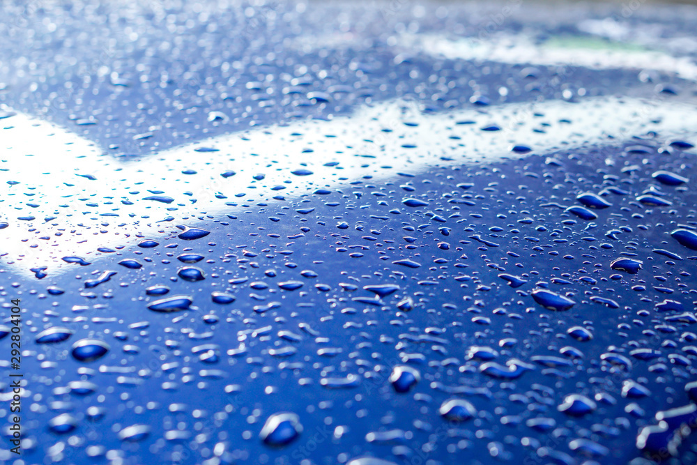 Background and texture of raindrops and reflection lighting on blue car engine hood. Background and texture of raindrops and reflection lighting on blue car engine hood.