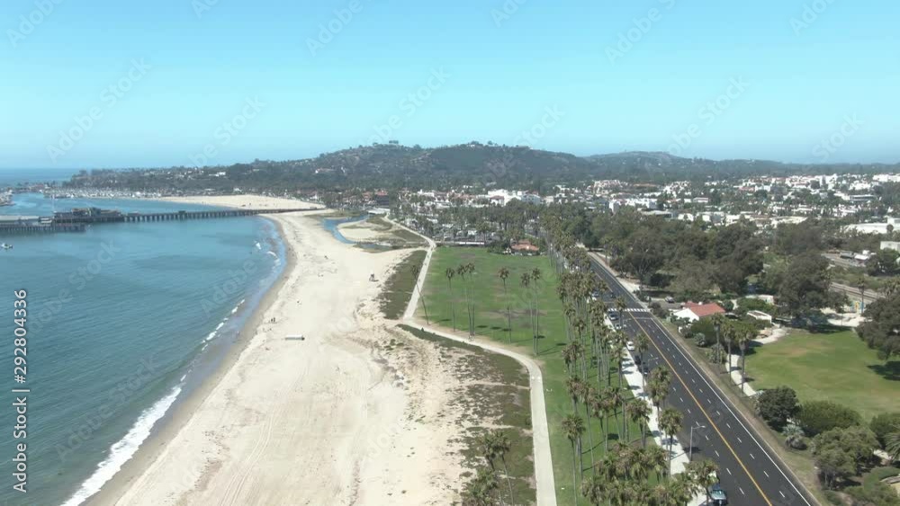 High altitude aerial over public beach and state park on the beach overseeing Sterns Wharf in Santa Barbara, California, USA. Some cars passing on Cabrillo boulevard. It's a sunny cloudless day. #2 High altitude aerial over public beach and state park on the beach overseeing Sterns Wharf in Santa Barbara, California, USA. Some cars passing on Cabrillo boulevard. It's a sunny cloudless day. #2