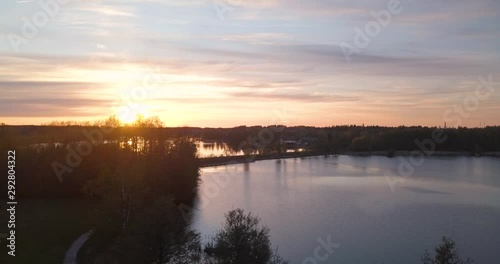 Sunset Over Lake and Scandinavian Forest in Sweden Aerial Drone Ascending Shot photo