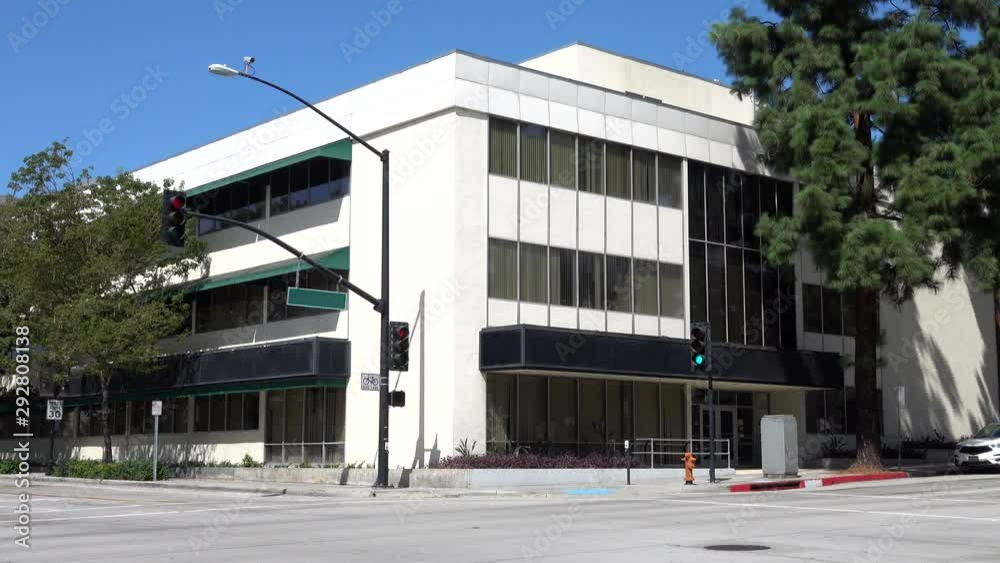 An older, unmarked government office building exterior is shown during ...