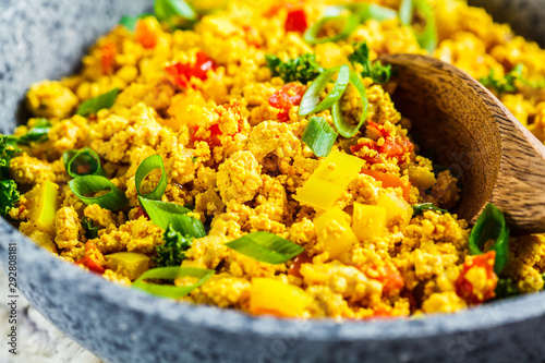 Tofu scramble with vegetables in a pan. Vegan Alternative Omelet.