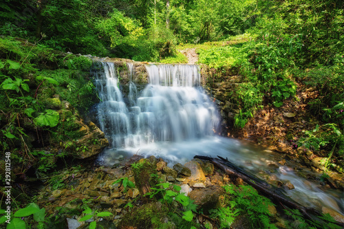 Waterfall in the forest, summertime outdoor backgriund