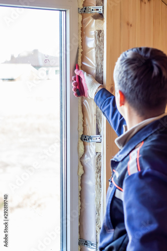 Insulation of windows foam. Construction of houses and apartments. Builder.