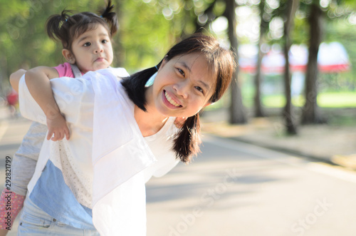 Little Child Girl and Mother at The Public Park