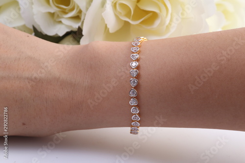 Fototapeta Gold and diamond heart shape bracelet.