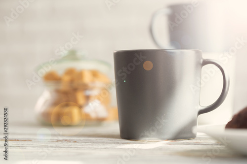 Cup of tea or coffee on modern kitchen background