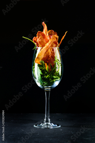 appetizer bacon chips on a dark background