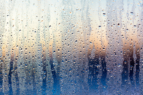 A foggy window at sunset as an abstract background