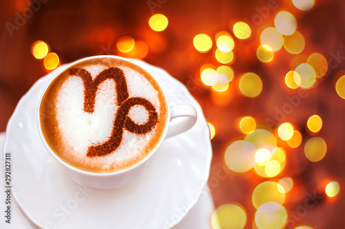 A cup of cappuccino coffee with a zodiac sign