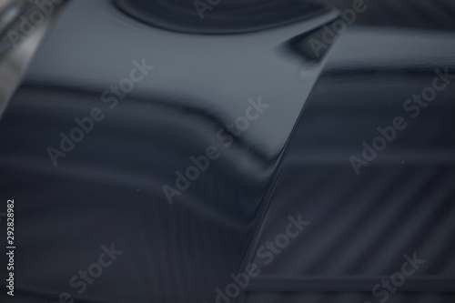 the metal surface of the car and headlight. Blue Pearl paint on the car