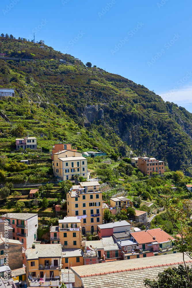 View of the houses in the Riomaggiore town. One of five famous centuries-old colorful villages of Cinque Terre National Park in Liguria, region of Italy.