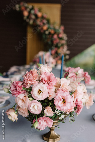 The beautiful, wedding bouquet on the holiday table adorns the table for guests