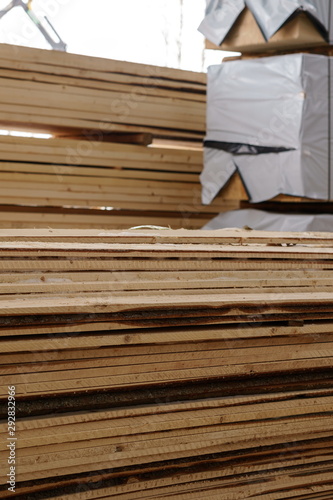 Image of wooden boards piled at sawmill