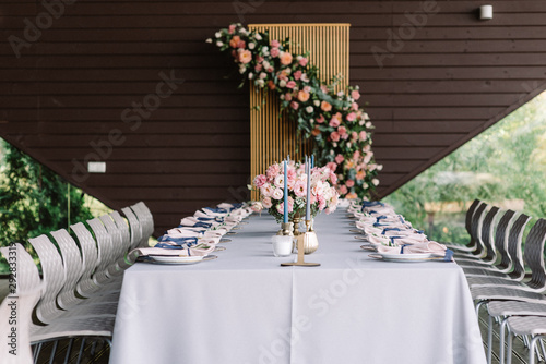 Carsy wedding table for guests in the restaurant decorated with flowers and stylish service