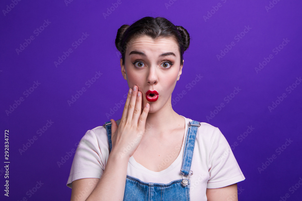 Wow woman emotion isolated on purple background at studio. Wow woman emotion isolated on purple background at studio.