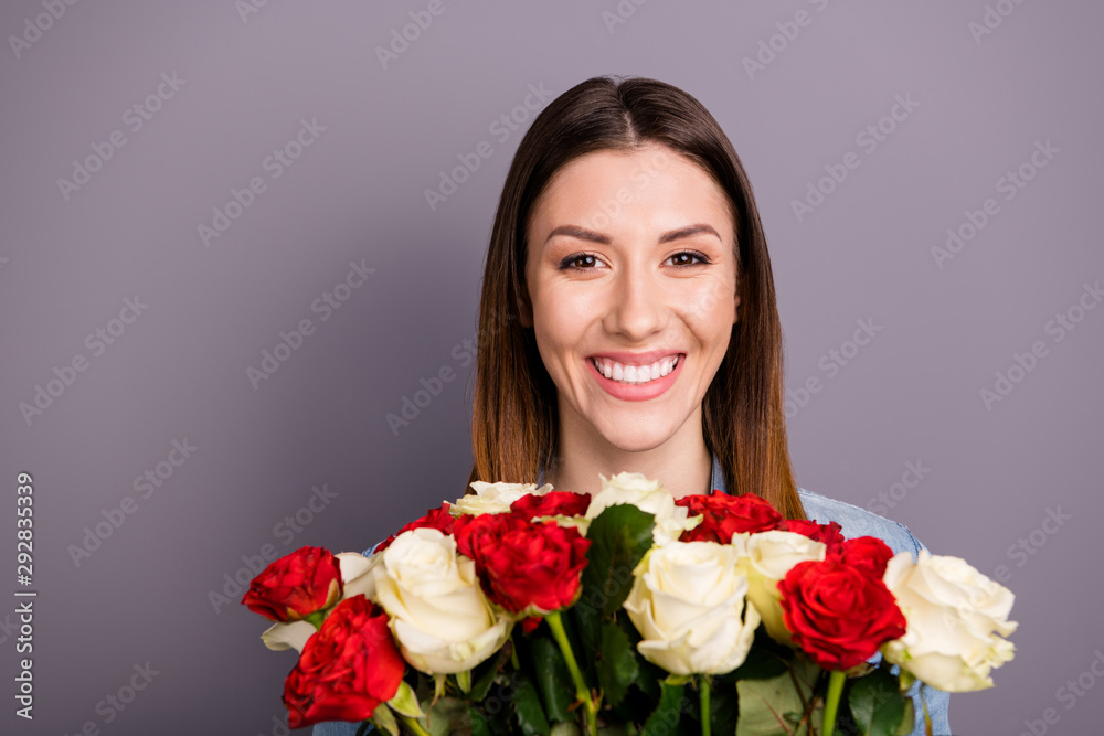 Close up photo of positive cheerful lady hold gift for birthday - bunch of flowers roses feel satisfied on party event wear denim jeans shirt isolated over grey color background Close up photo of positive cheerful lady hold gift for birthday - bunch of flowers roses feel satisfied on party event wear denim jeans shirt isolated over grey color background