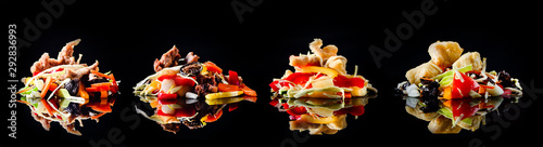 Concept of Asian cuisine. set of WOKs on a black background with reflection