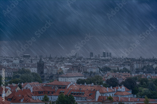 Prague panorama overlooking Charles Bridge and skyscrapers in a business center in heavy rain