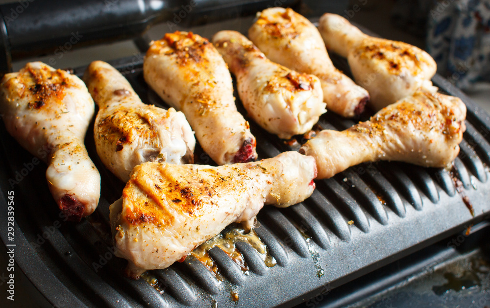 Marinated chicken legs fried on the hot flaming BBQ grill. Marinated chicken legs fried on the hot flaming BBQ grill.