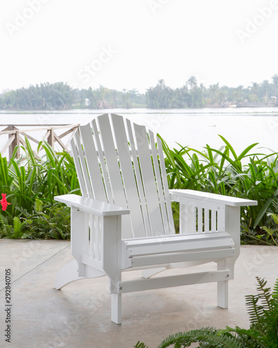 The white wood beach chair in the backyard