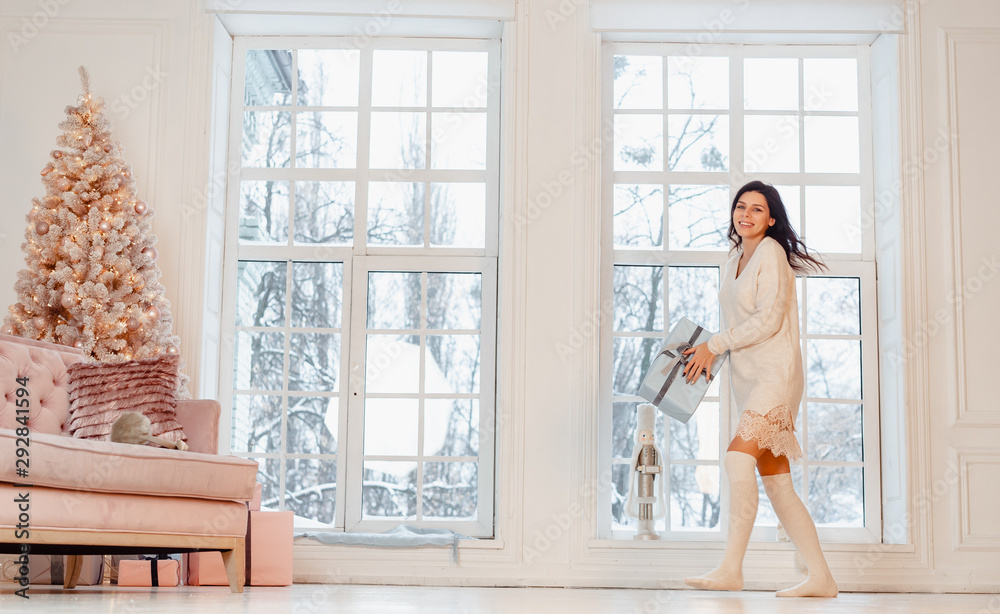 Beautiful young girl in white dress posing on camera. Christmas concept Beautiful young girl in white dress posing on camera. Christmas concept