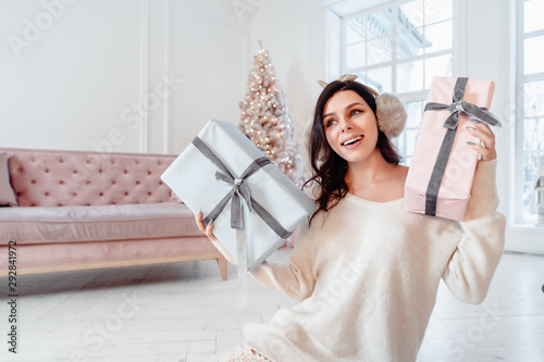 Beautiful young girl in white dress posing on camera. Christmas concept photo