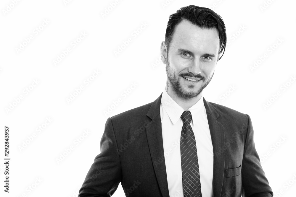 Studio shot of young happy businessman smiling Studio shot of young happy businessman smiling