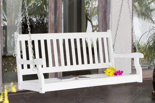 The white wood swing in the backyard.