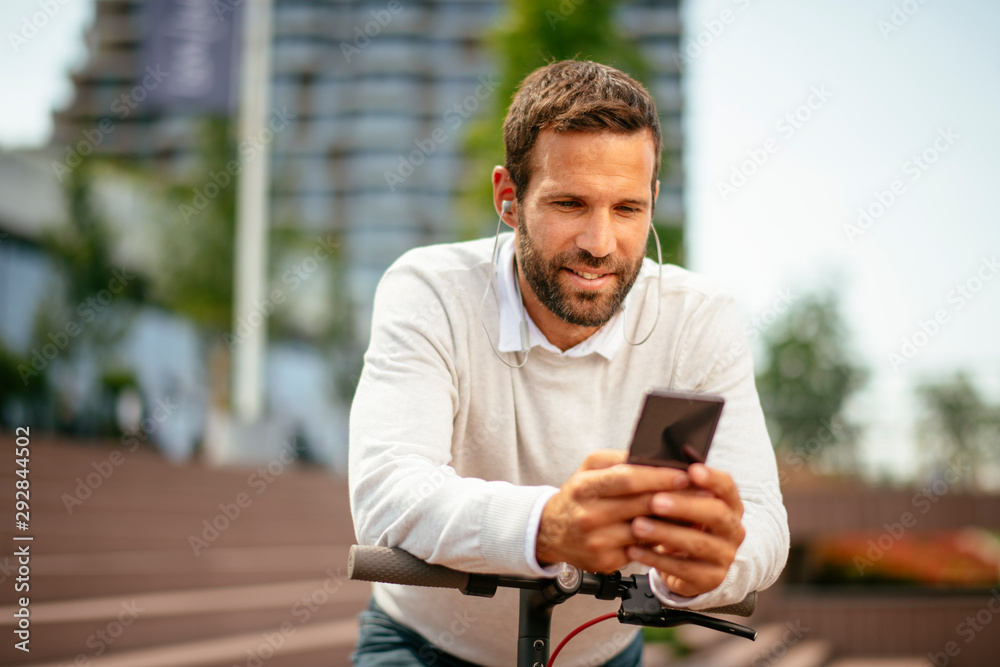 Close up of man on electric scooter listening music