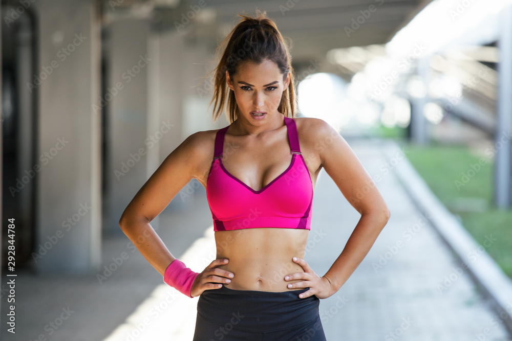 Healthy sports lifestyle. Athletic young woman in sports dress doing fitness exercise. Fitness woman streching Relaxing after training.