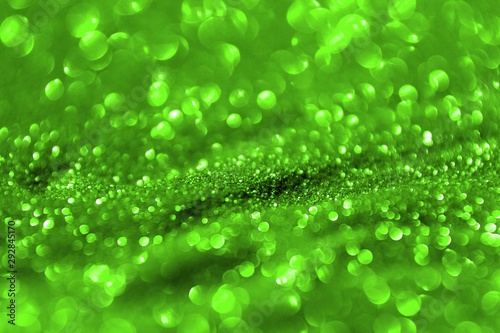 green bright brassy sand made of glitters - celebratory concept with bokeh texture - fantastic abstract photo background