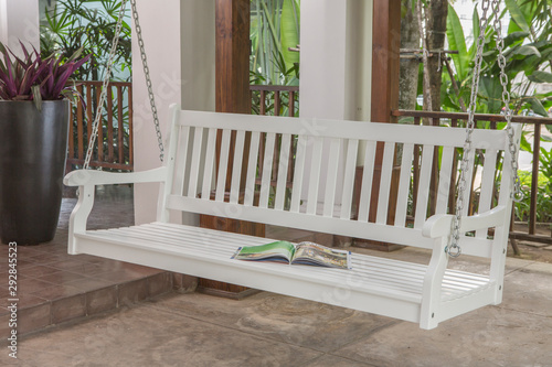 The white wood swing in the backyard.