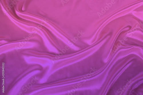 soft folds on delicate pink, lilac shining silk, luxury concept, background for the designer, horizontal, close-up, copy space
