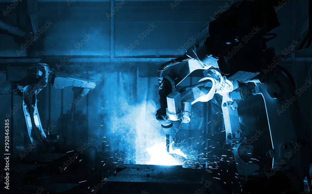 automate wireless Robot arm in smart factory background. Mixed media of welding robot in the automotive parts industry