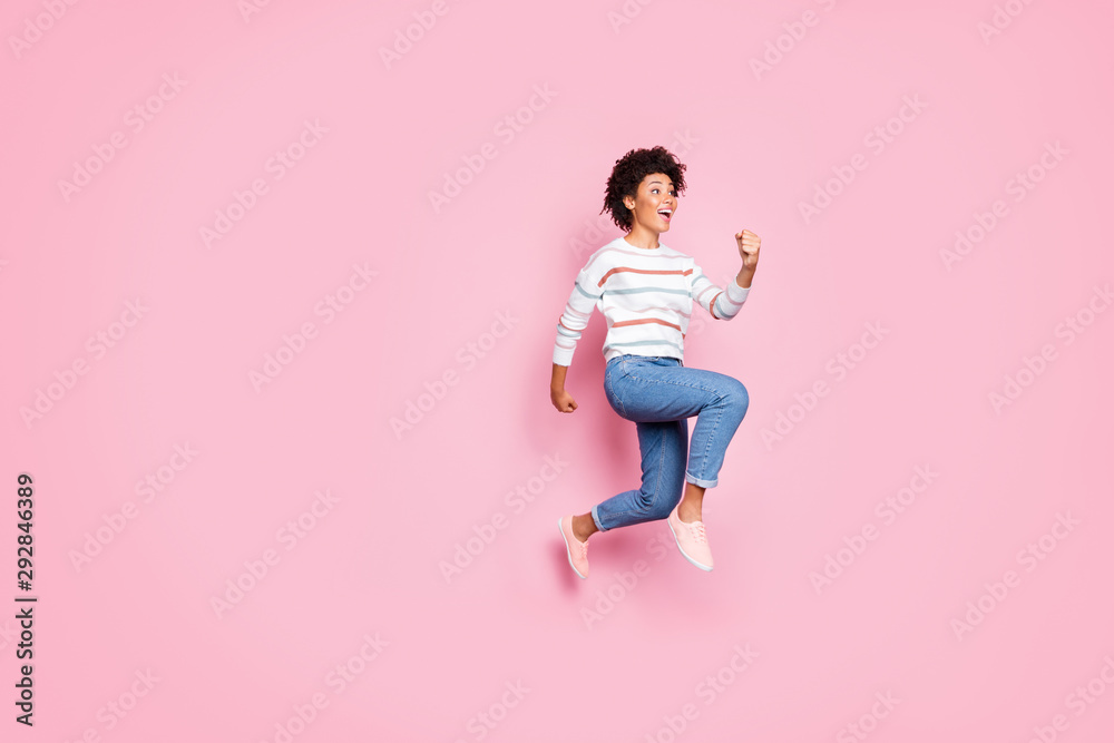 Full length body size photo of cute charming cheerful astonished shocked black youngster running jumping towards sales with emotions on face jeans denim sweater striped isolated pastel color Full length body size photo of cute charming cheerful astonished shocked black youngster running jumping towards sales with emotions on face jeans denim sweater striped isolated pastel color