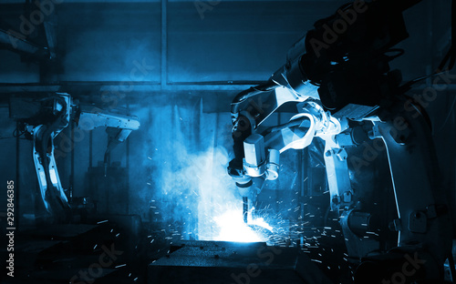 Obraz na płótnie automate wireless Robot arm in smart factory background. Mixed media of welding robot in the automotive parts industry w salonie